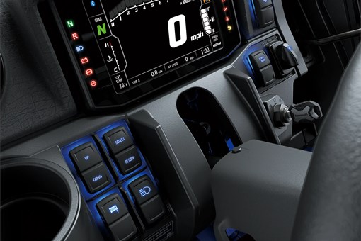 Close-up on a side x side infotainment screen and buttons. opens in a new window