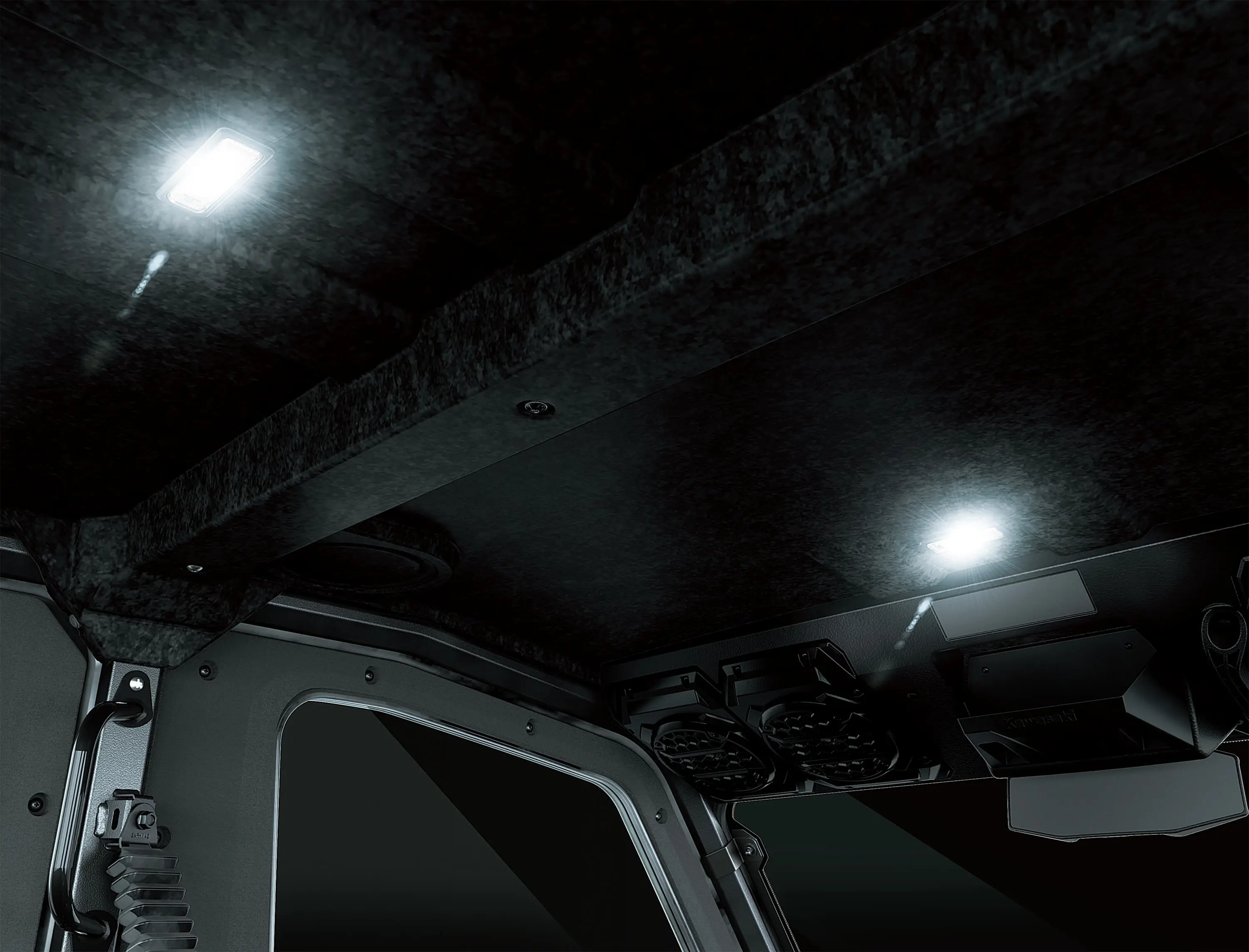 Overhead lights inside a side x side interior.