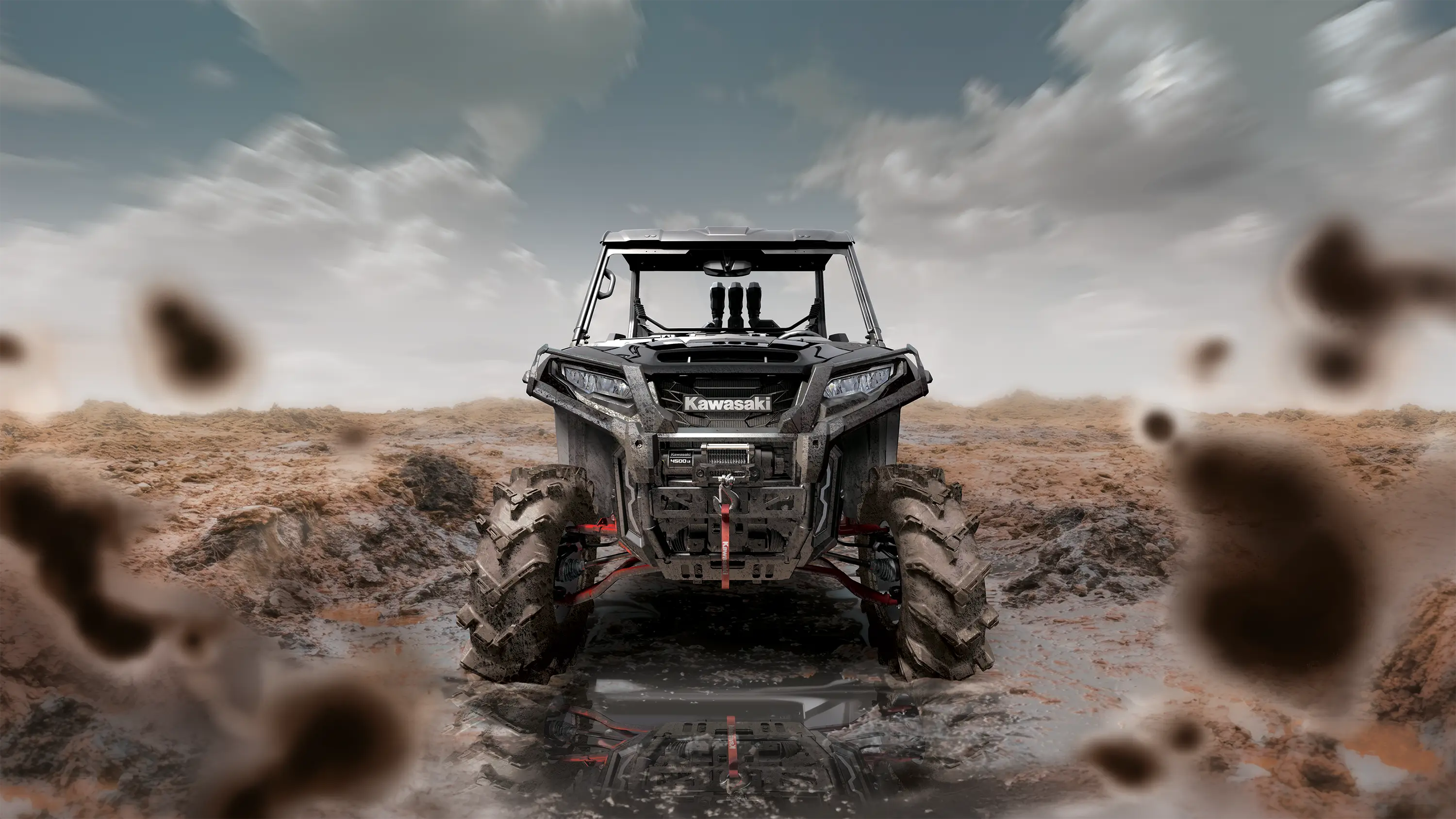 Front angle of a person driving a side x side through mud.