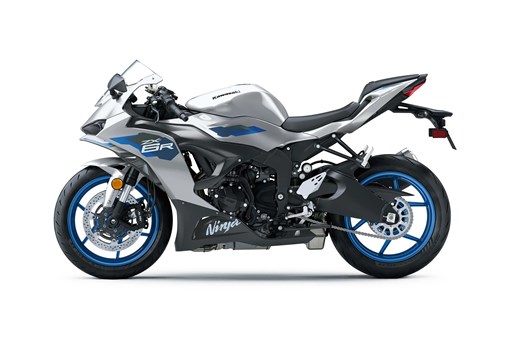 Profile angle of a silver motorcycle staged in a white studio background. opens in a new window