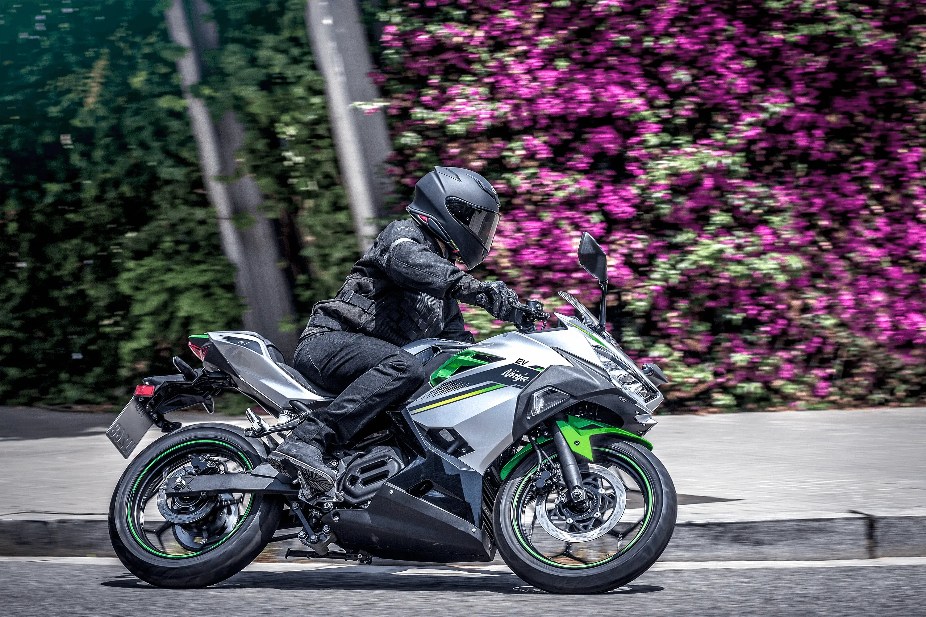 Side angle of a person on a motorcycle making a turn.