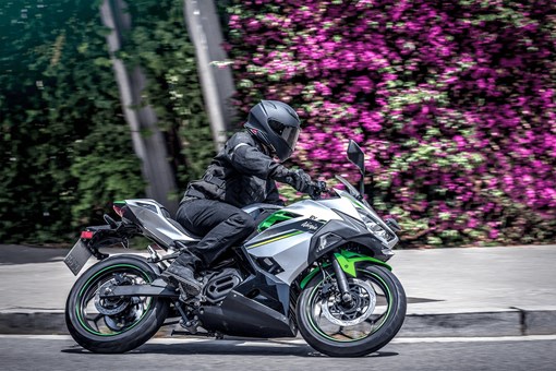 Side angle of a person on a motorcycle making a turn. opens in a new window