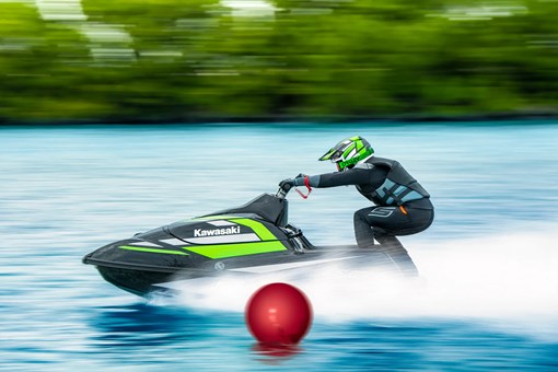 Person speeding past buoy on the water. opens in a new window