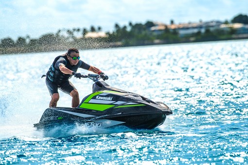 Side angle of a person on a personal watercraft on the water. opens in a new window