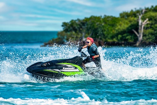 Profile angle of a person on a personal watercraft on the water. opens in a new window