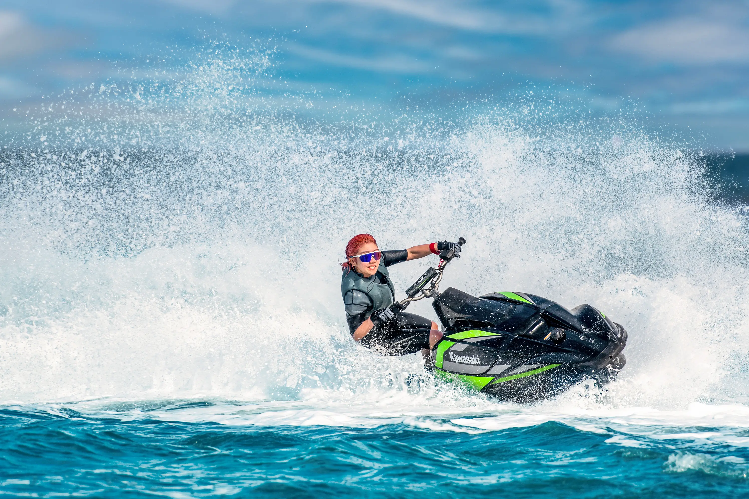 Person turning on a personal watercraft on the water.