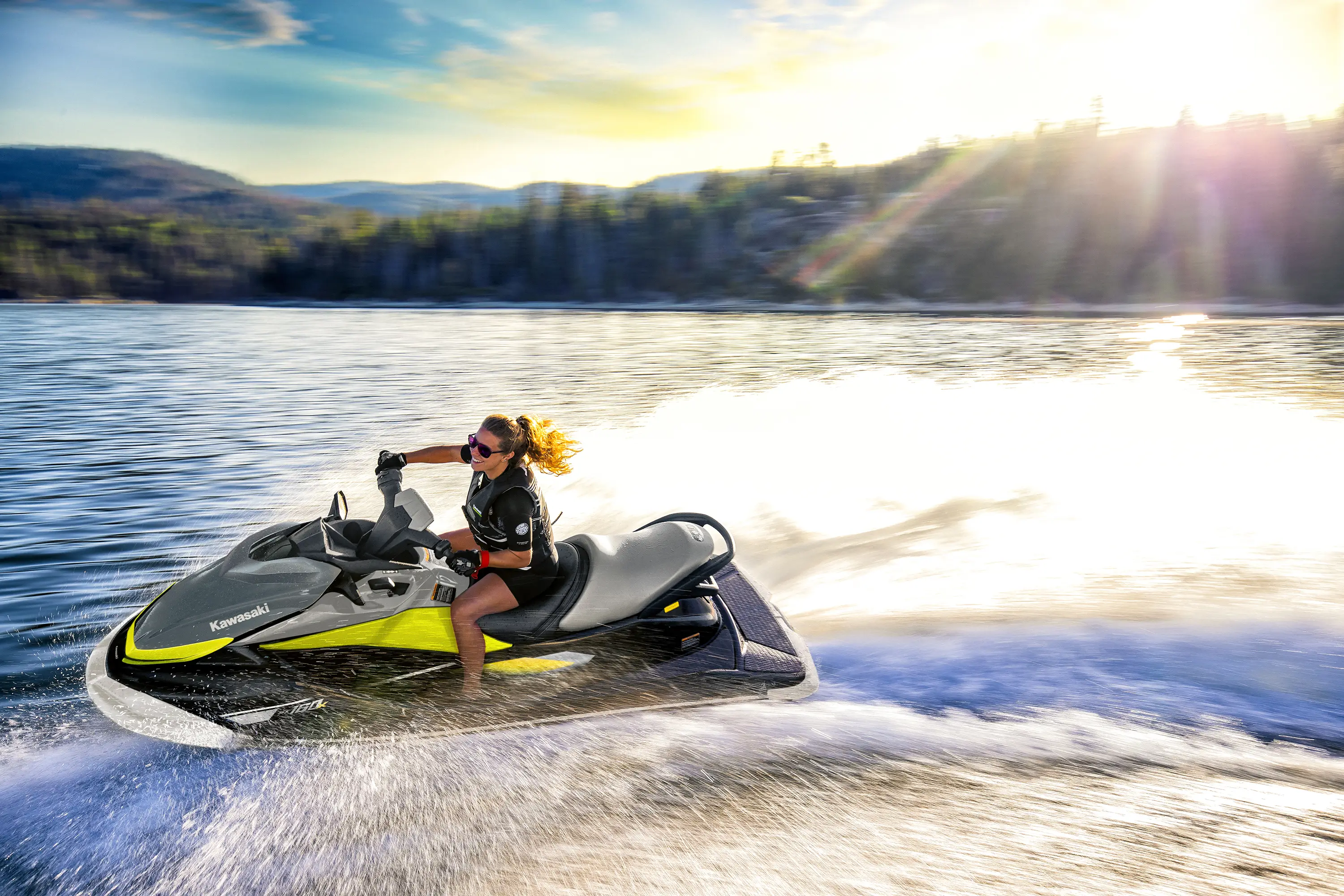 Side angle of a person turning on a personal watercraft on the water.