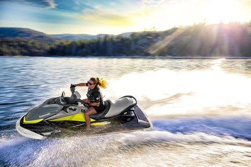 Side angle of a person turning on a personal watercraft on the water. opens in a new window