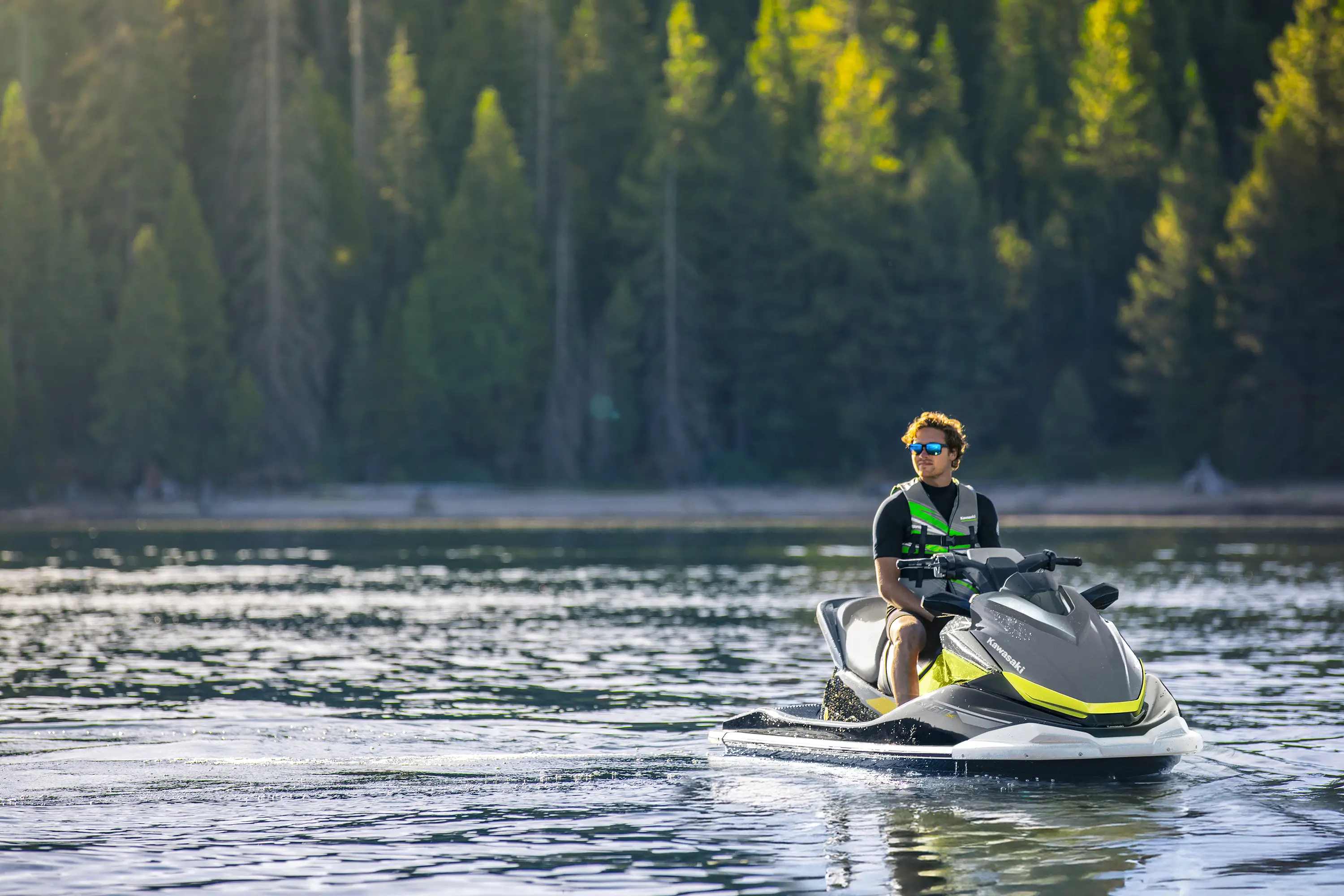 Person sitting on a watercraft on the water.