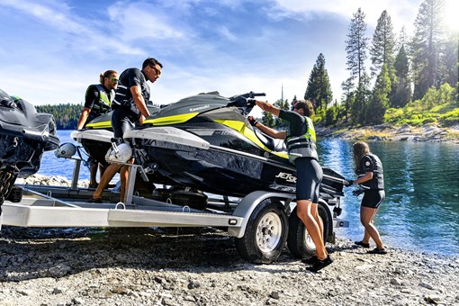Personal watercraft being unloaded from a trailer into the water. opens in a new window