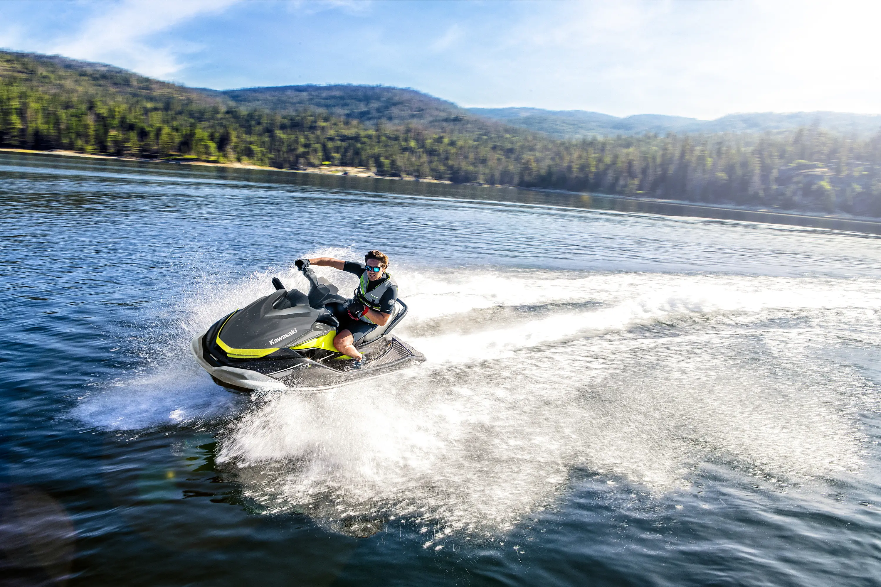 Profile angle of a person turning on a personal watercraft on the water.