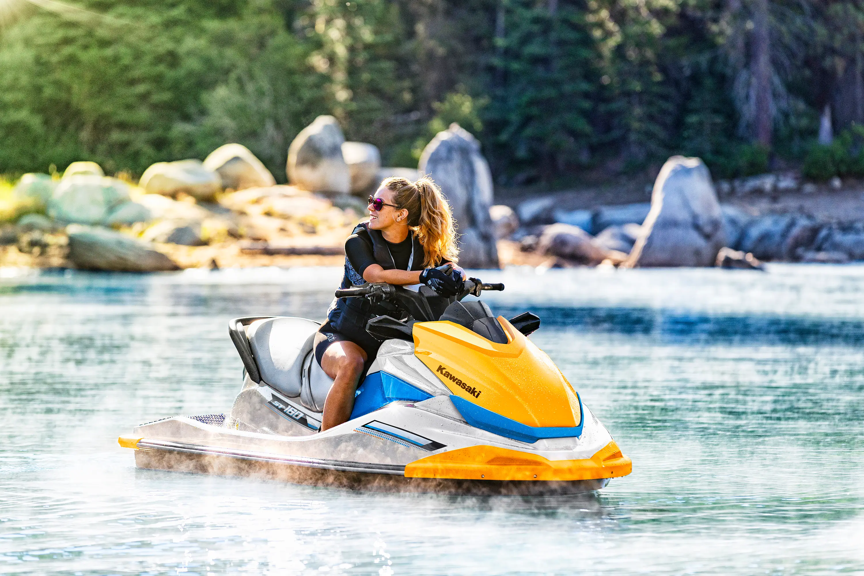 Person sitting on a watercraft on the water.