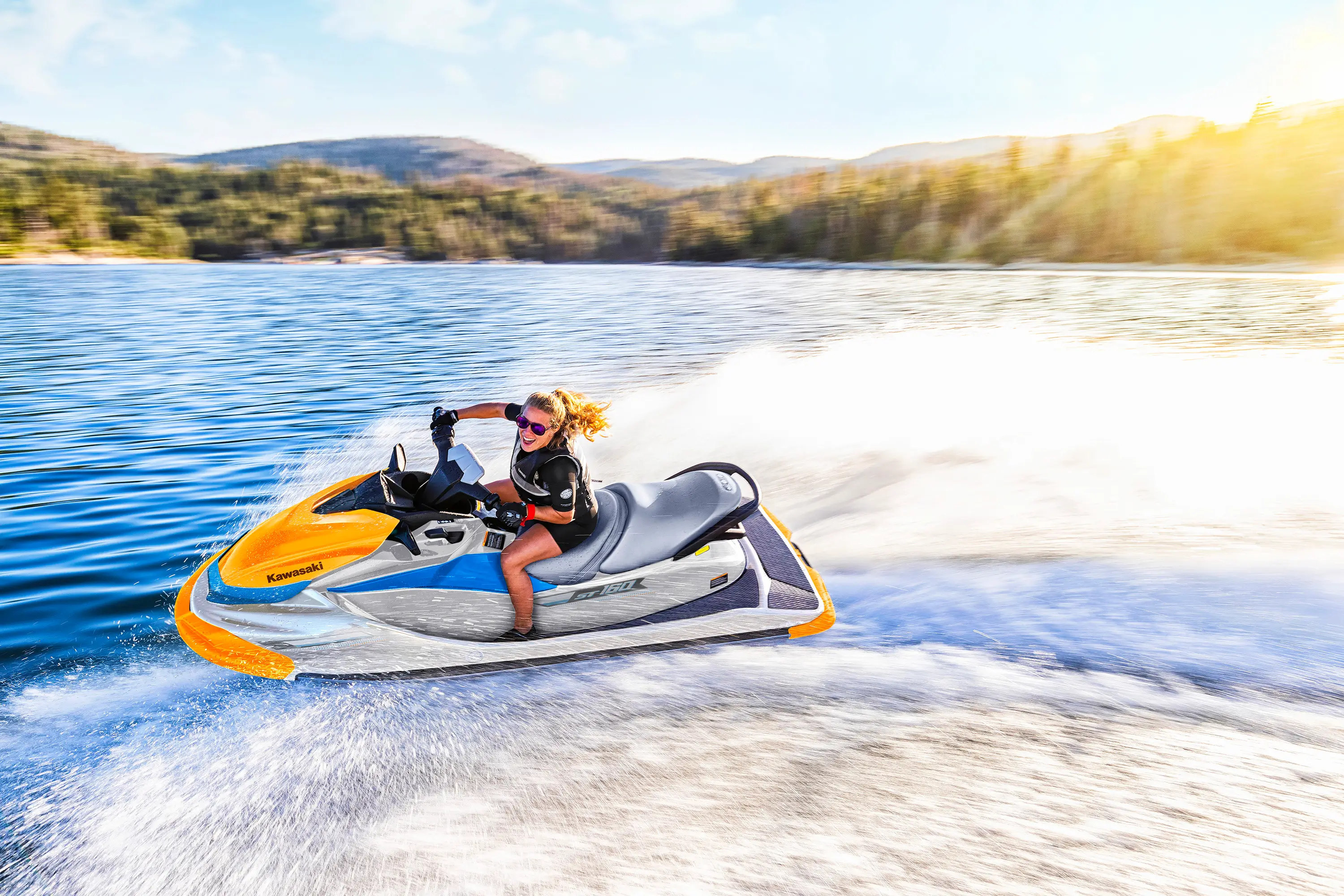 Side angle of a person on a personal watercraft on the water.