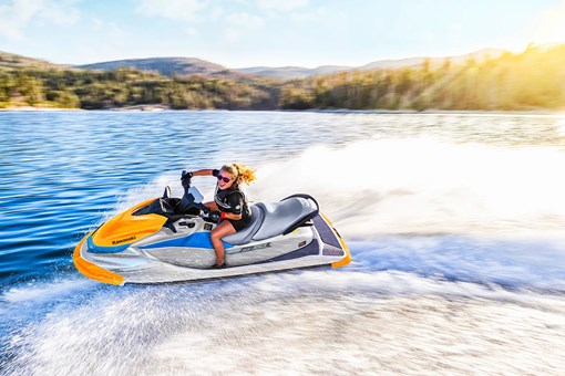 Side angle of a person on a personal watercraft on the water. opens in a new window