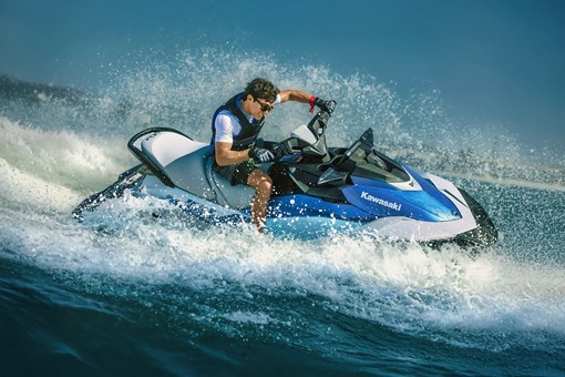 Side angle of a person turning on a personal watercraft on the water. opens in a new window
