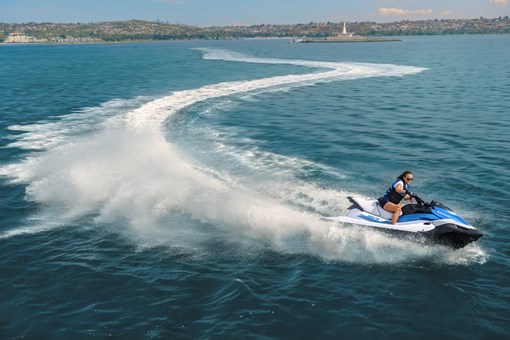 Profile angle of a person turning on a personal watercraft on the water. opens in a new window