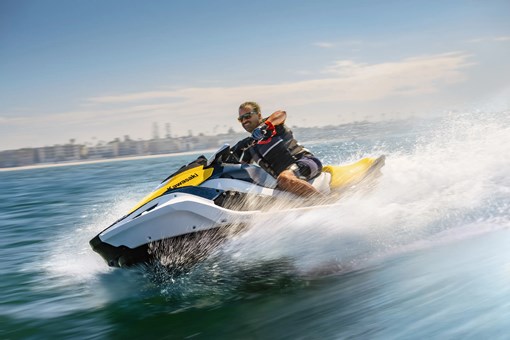 Side angle of a person on a personal watercraft on the water. opens in a new window