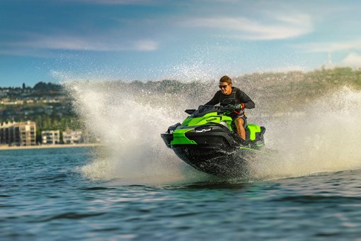 Three-quarter front angle of a person on a personal watercraft on the water. opens in a new window
