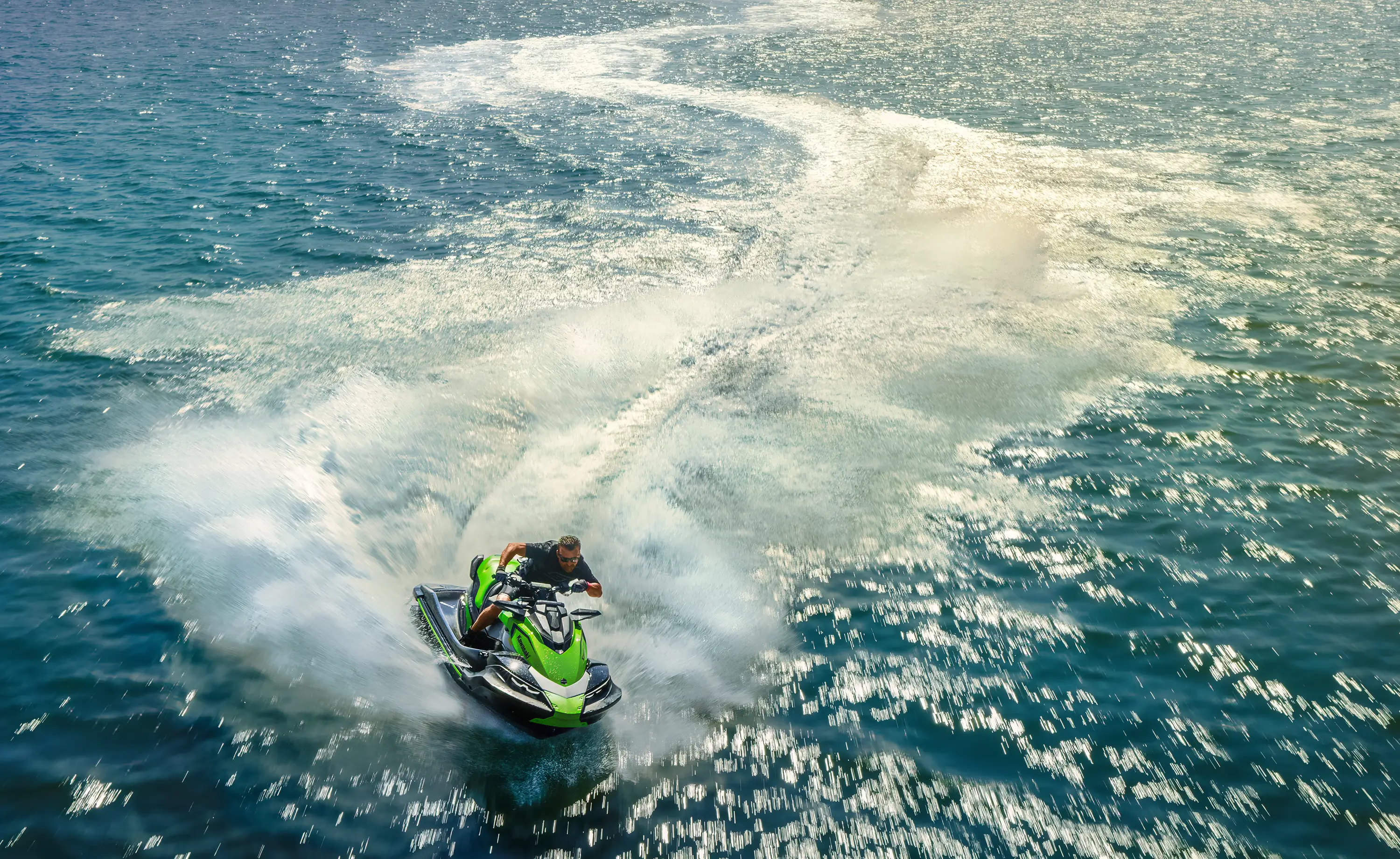Overhead shot of a person on a personal watercraft on the water.