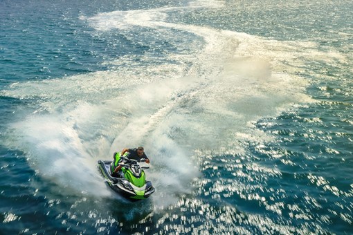 Overhead shot of a person on a personal watercraft on the water. opens in a new window