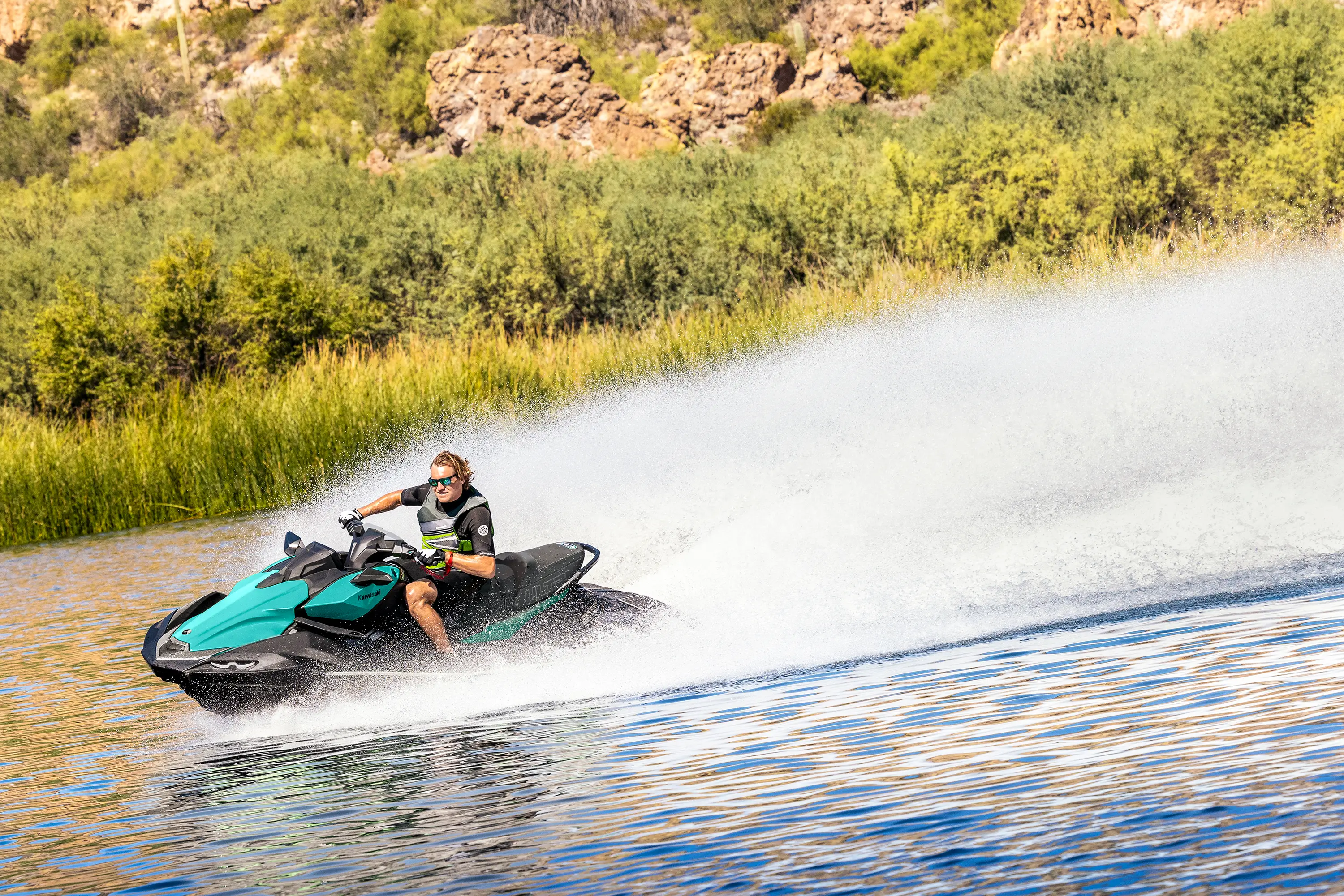 Person turning a personal watercraft on the water.