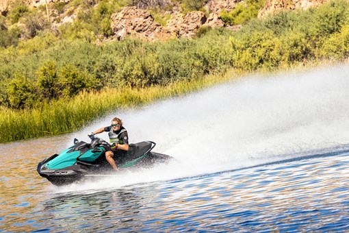 Person turning a personal watercraft on the water. opens in a new window