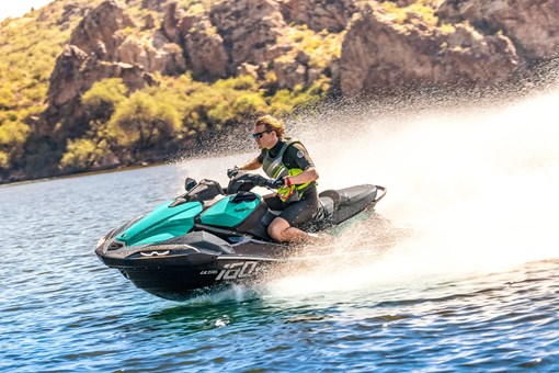 Side angle of a person on a personal watercraft on the water. opens in a new window