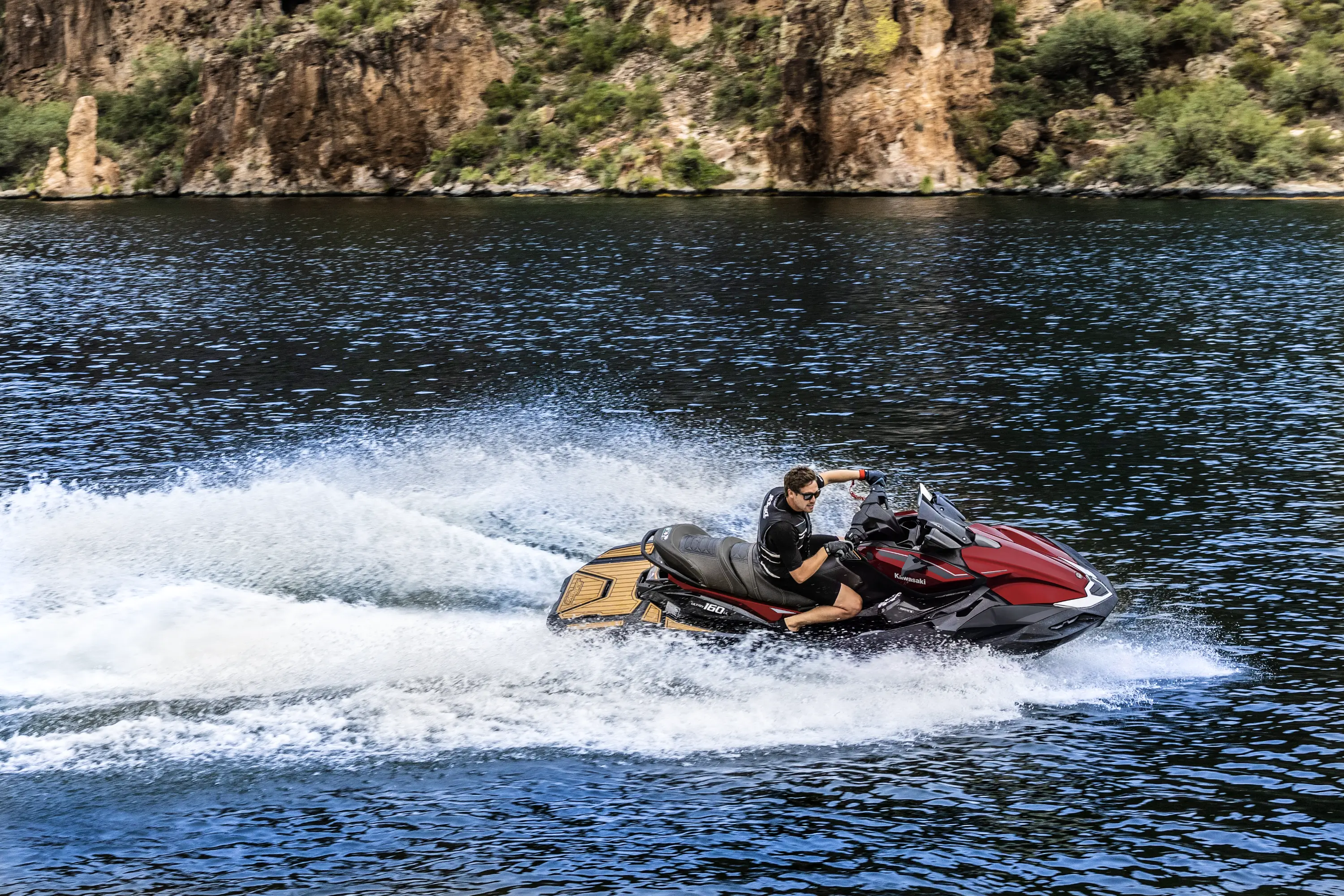 Person turning a personal watercraft on the water.