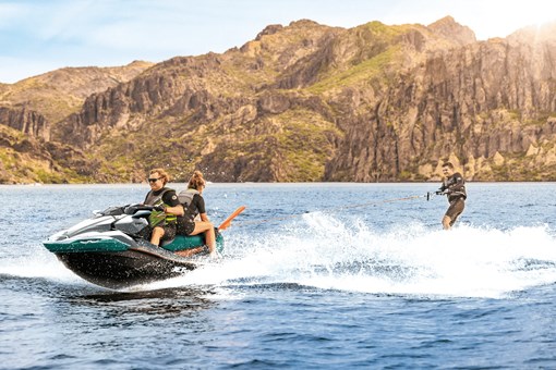 A person being towed behind a personal watercraft on the water. opens in a new window