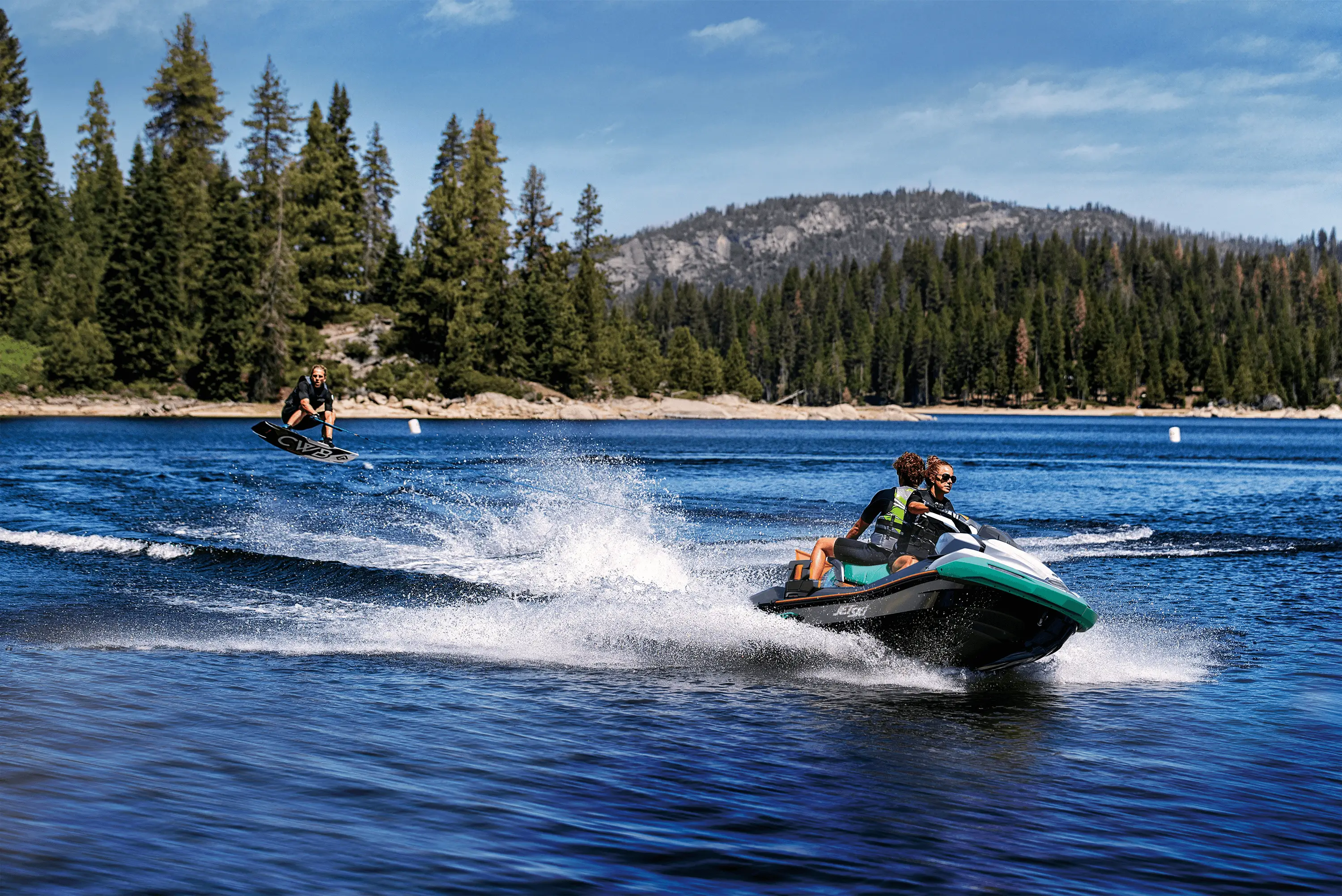 A person being towed behind a personal watercraft on a lake.