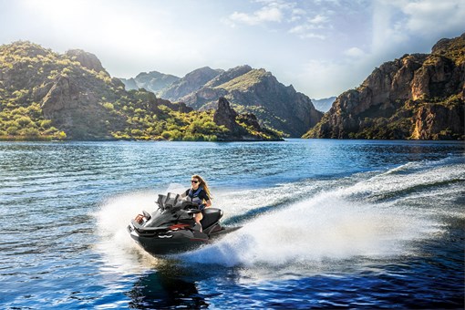 Front three-quarter angle of a person on a personal watercraft on the water. opens in a new window