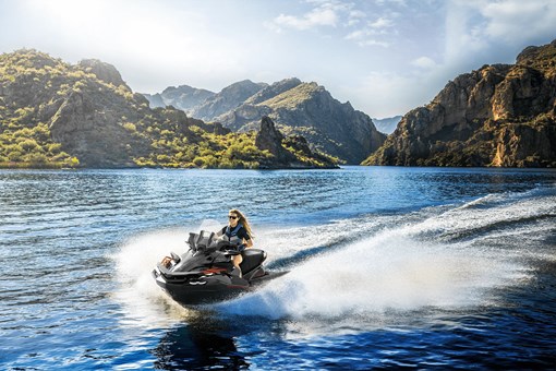 Front three-quarter angle of a person on a personal watercraft on the water. opens in a new window