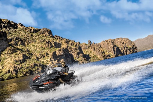 Three-quarter front angle of a person on a personal watercraft on the water. opens in a new window