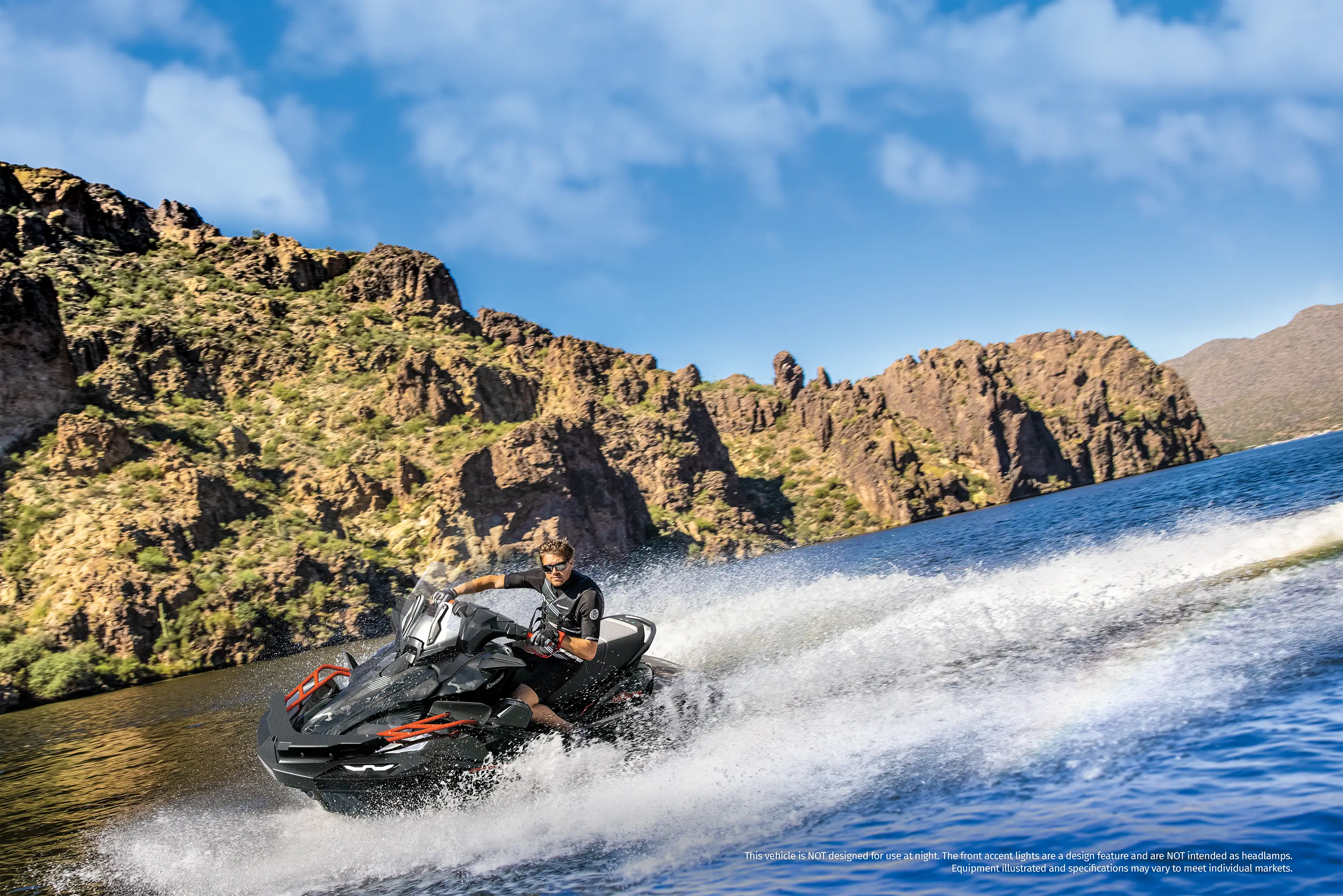 Three-quarter front angle of a person on a personal watercraft on the water.