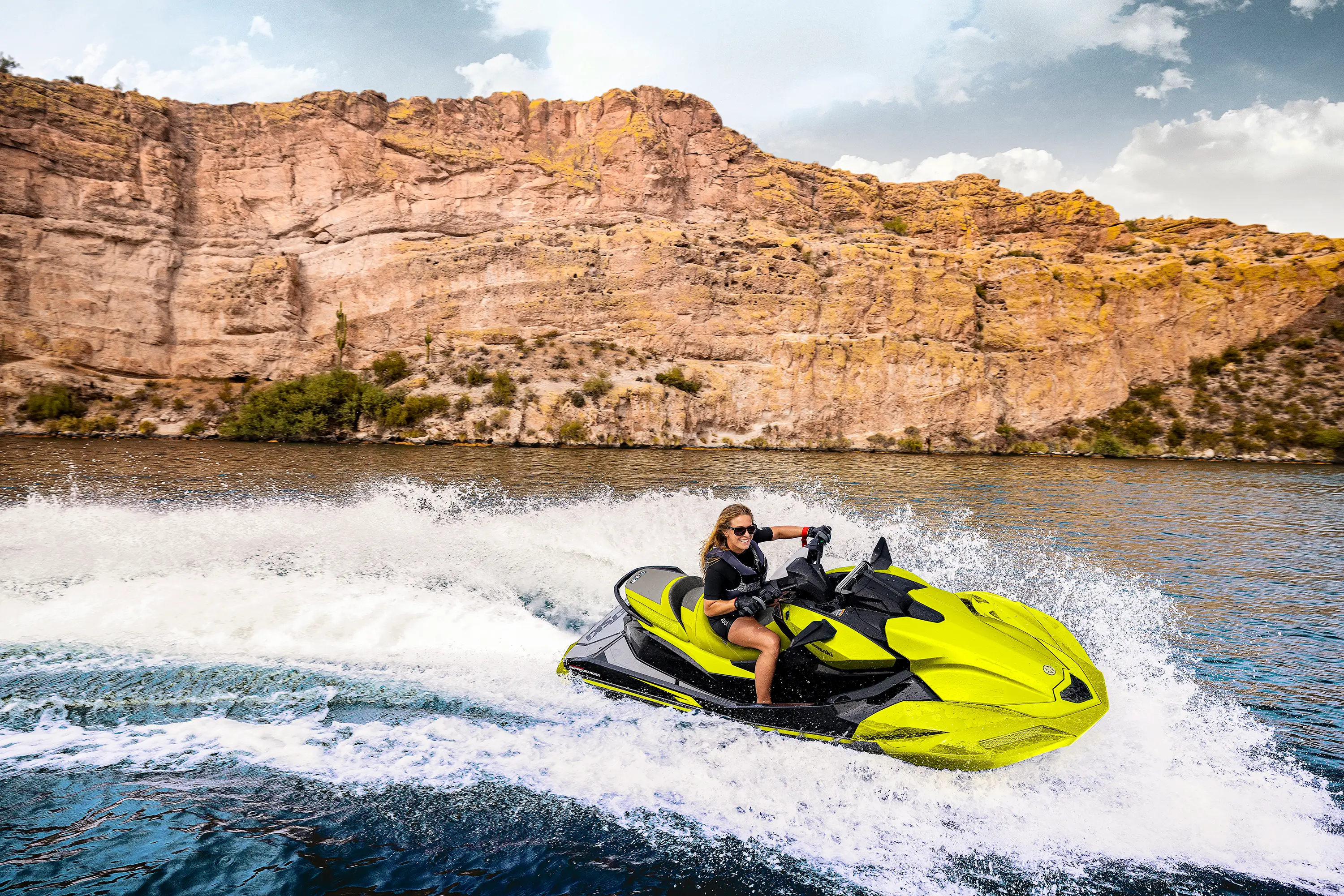 Person turning a personal watercraft on the water.