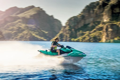 Side angle of a person on a personal watercraft on the water. opens in a new window