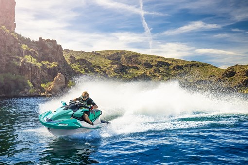 Three-quarter front angle of a person on a personal watercraft on the water. opens in a new window