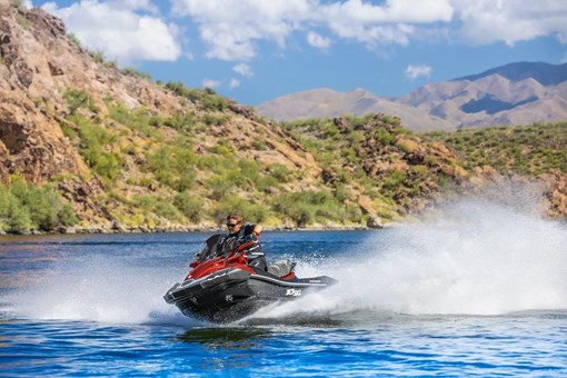 Front three-quarter angle of a person on a personal watercraft on the water. opens in a new window