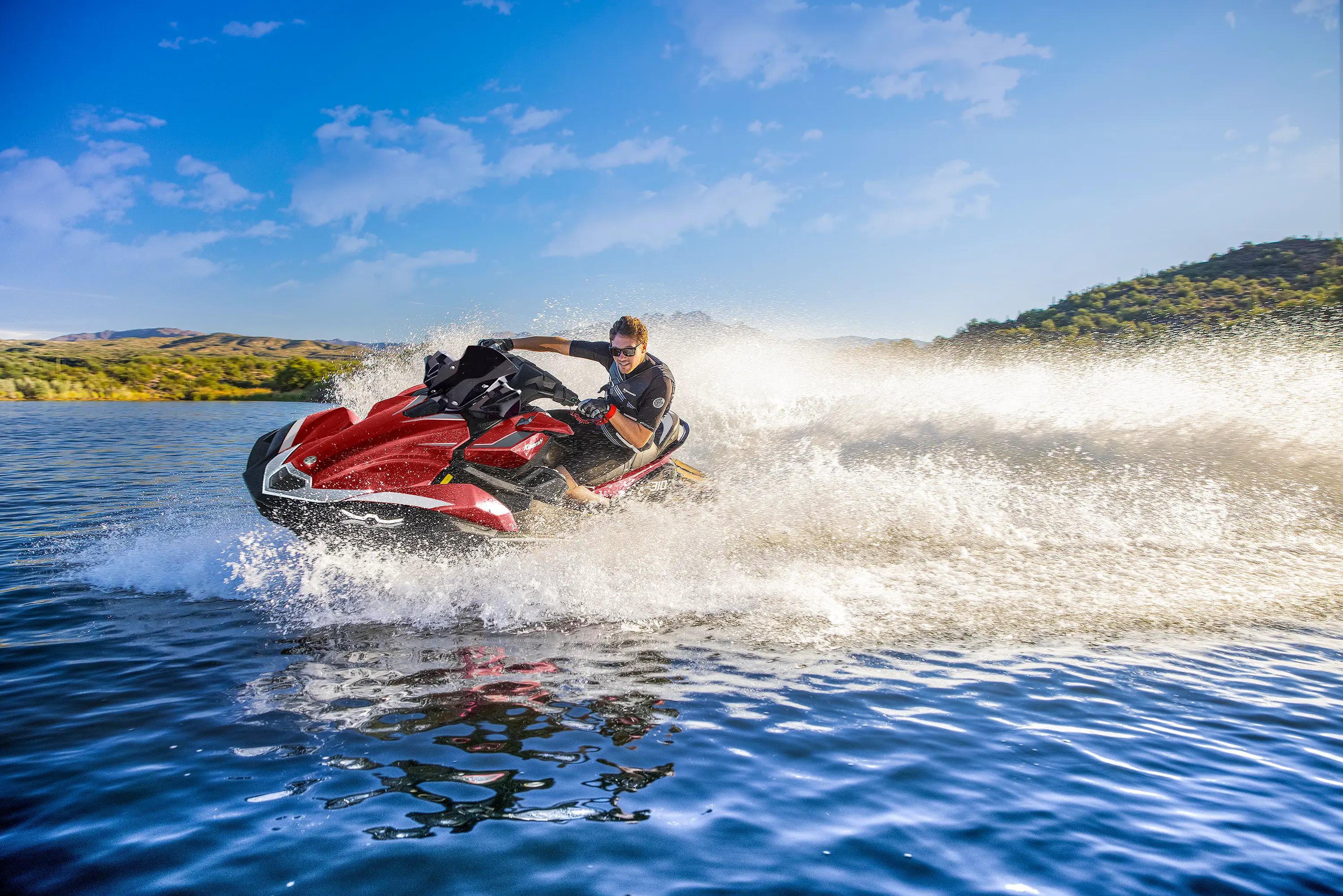Person turning a personal watercraft on the water.