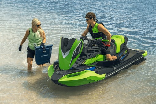 Two people finishing a day on the water parked at the shoreline. opens in a new window
