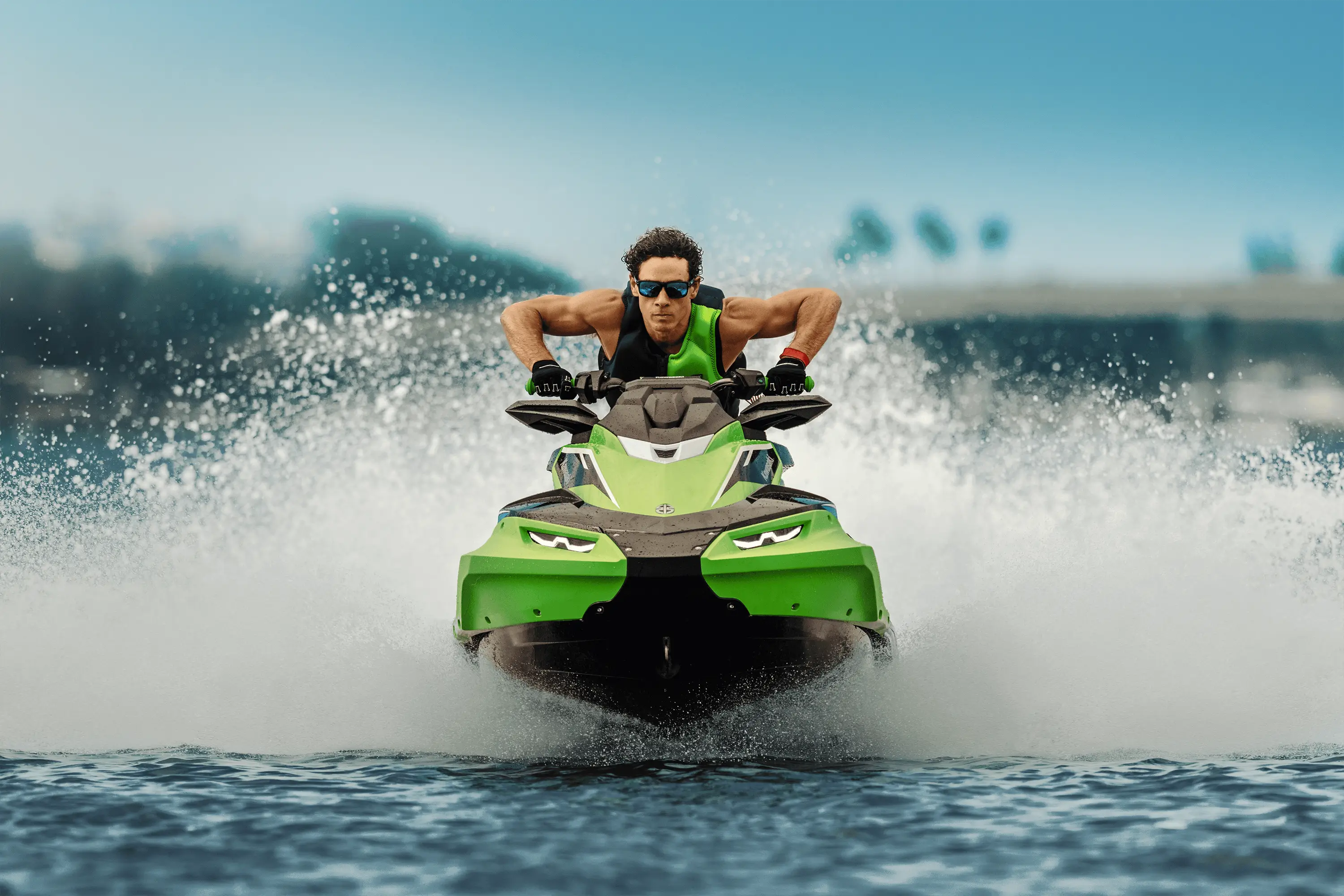 Close front angle of a person on a personal watercraft on the water.