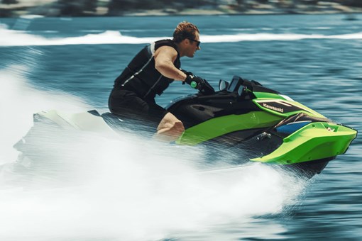 Side angle of a person on a personal watercraft on the water. opens in a new window
