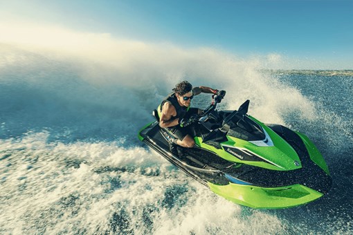 Three-quarter front angle of a person on a personal watercraft on the water. opens in a new window