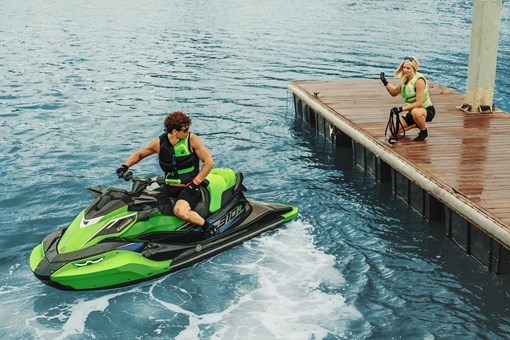 Person on a watercraft backing up to a dock. opens in a new window