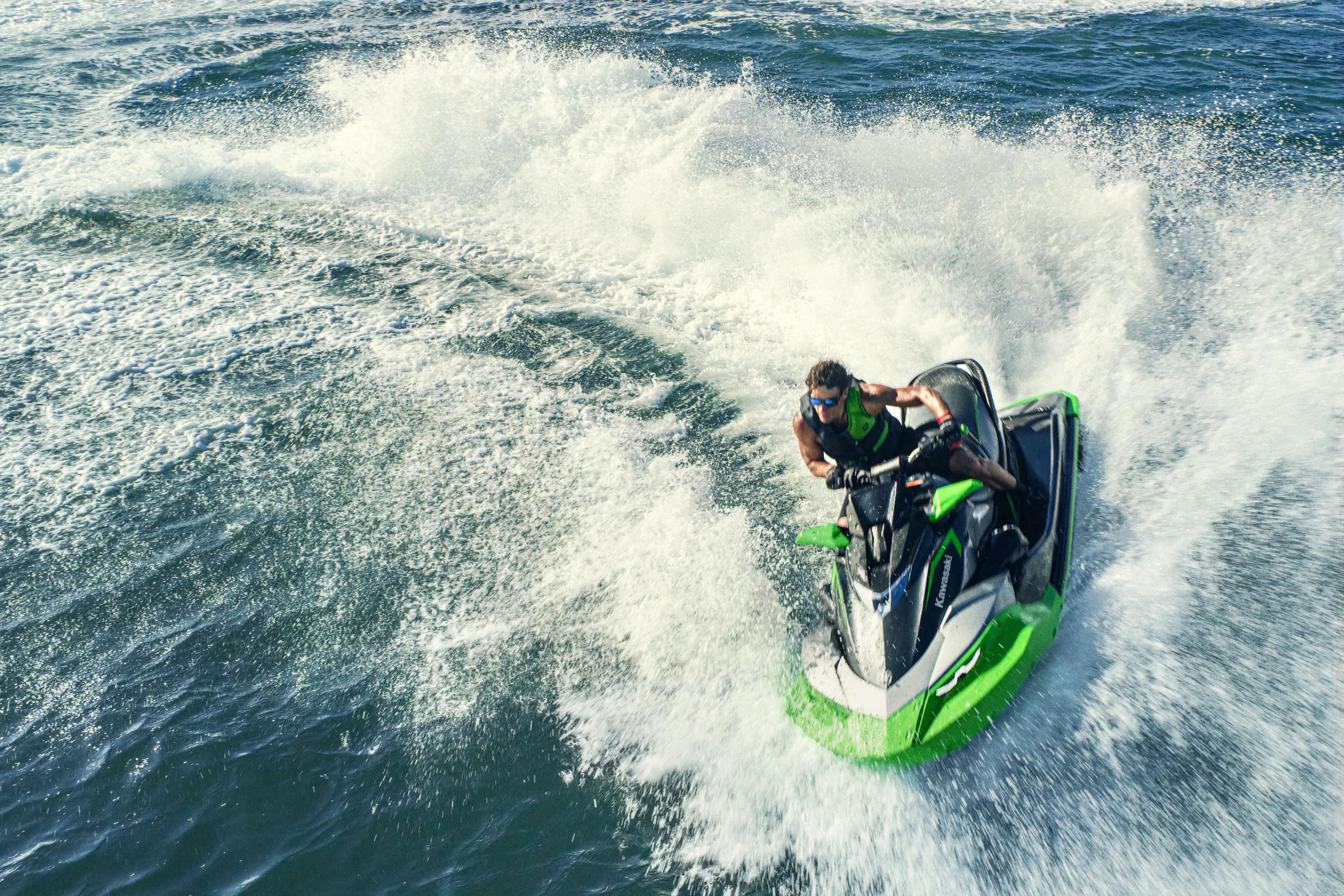 Overhead of a person turning on a personal watercraft.
