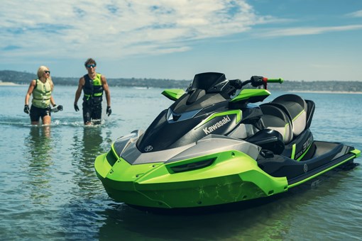 Personal watercraft sitting in the water with two people nearby. opens in a new window