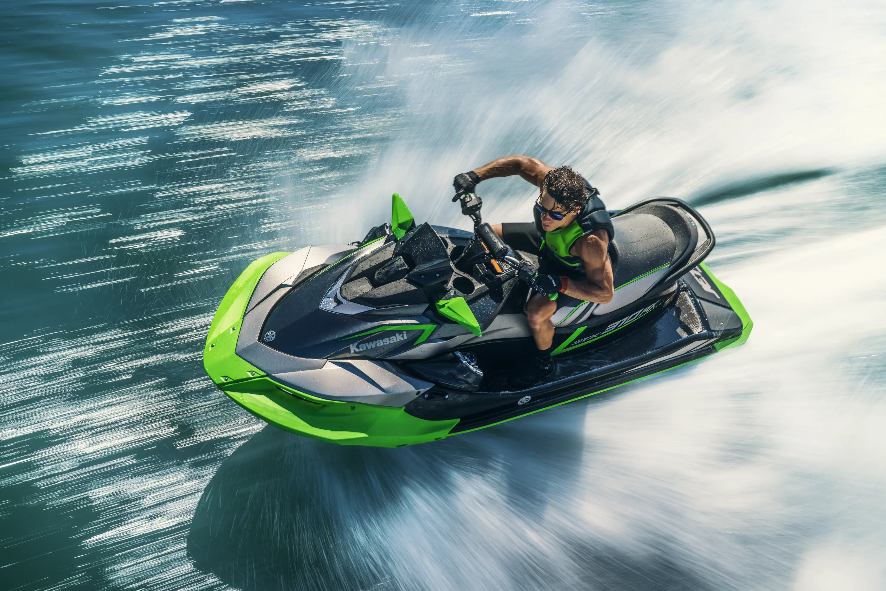 Over top of two people on a personal watercraft.