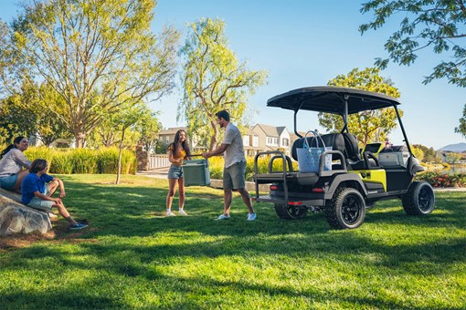 Three-quarter rear angle of a Neighborhood Activity Vehicle parked on grass. opens in a new window