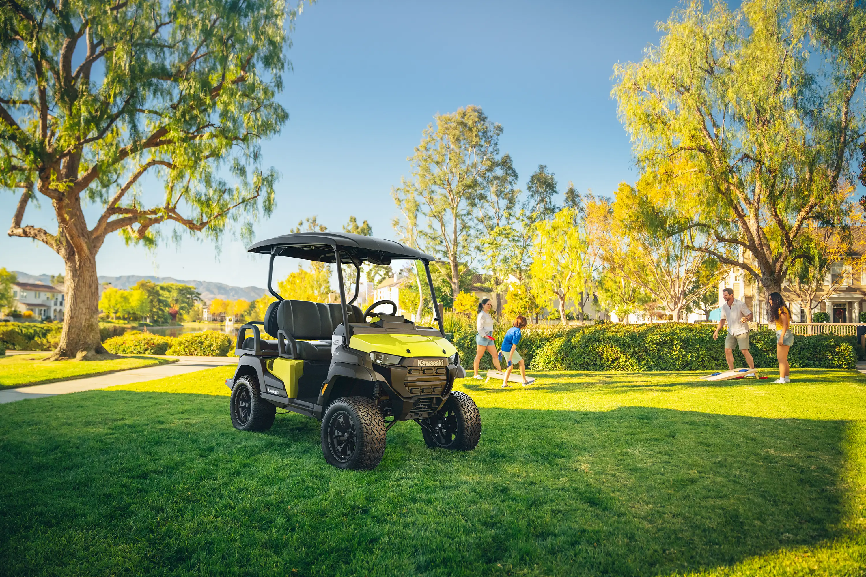 Three-quarter front angle of a Neighborhood Activity Vehicle parked on grass.