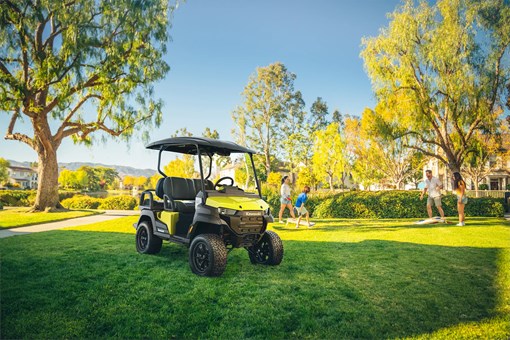 Three-quarter front angle of a Neighborhood Activity Vehicle parked on grass. opens in a new window